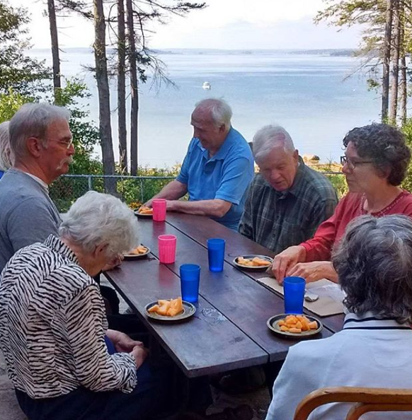 Residents enjoy meals on the patio, overlooking Casco bay.